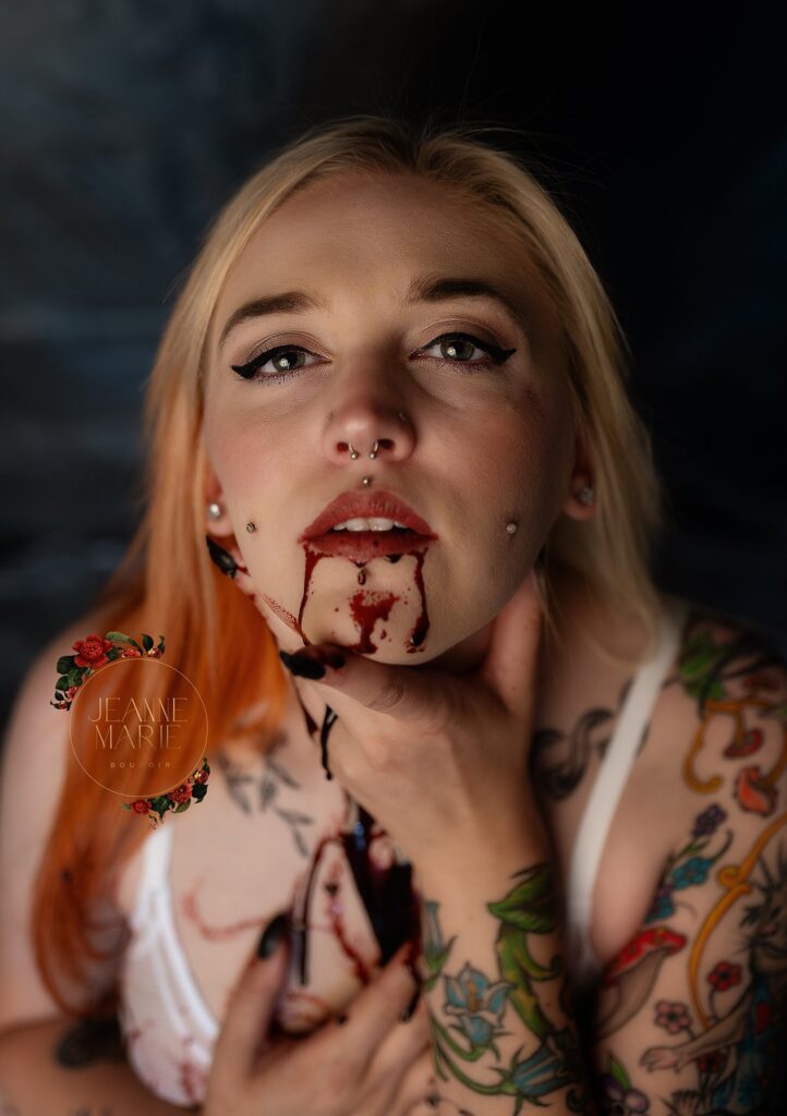 Close-up of Abigail with faux blood on her face during her Dexter-themed Halloween boudoir session in Tulia, Texas