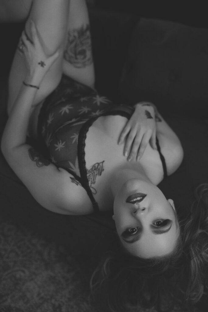 Black and white image of Jara smiling during a Halloween boudoir session in Tulia, Texas.
